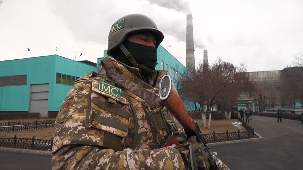 A CSTO peacekeeper from Kyrgyzstan stands guard outside a power station in Almaty.