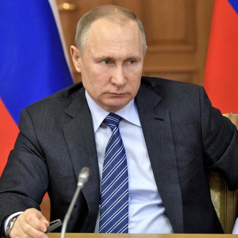 Putin frowning with flags