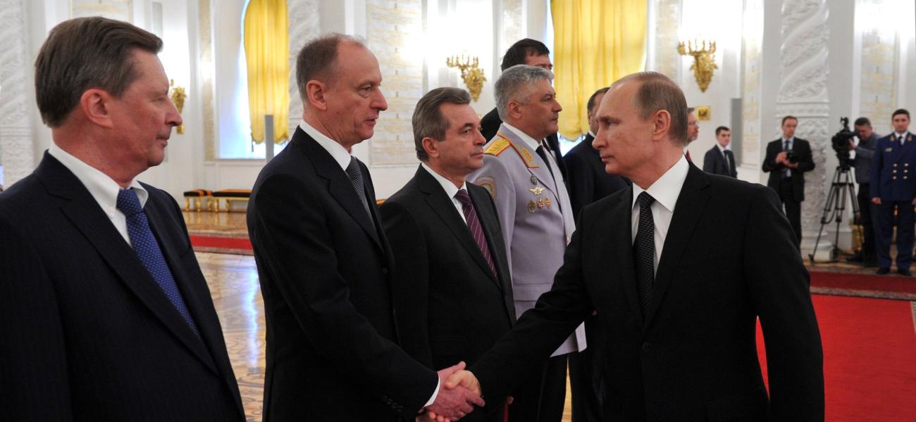 Patrushev shakes hands with Putin