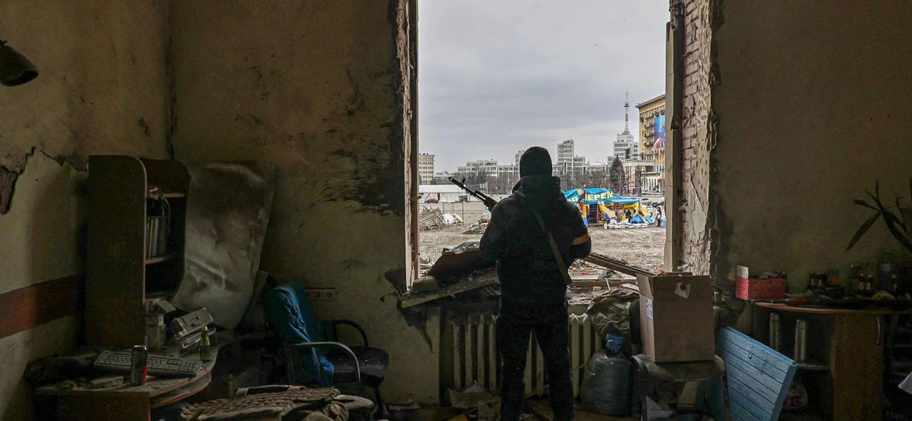 A member of the Territorial Defense Forces of Ukraine stands inside the damaged Kharkiv regional administration building in the aftermath of a shelling in downtown Kharkiv on March 1.
