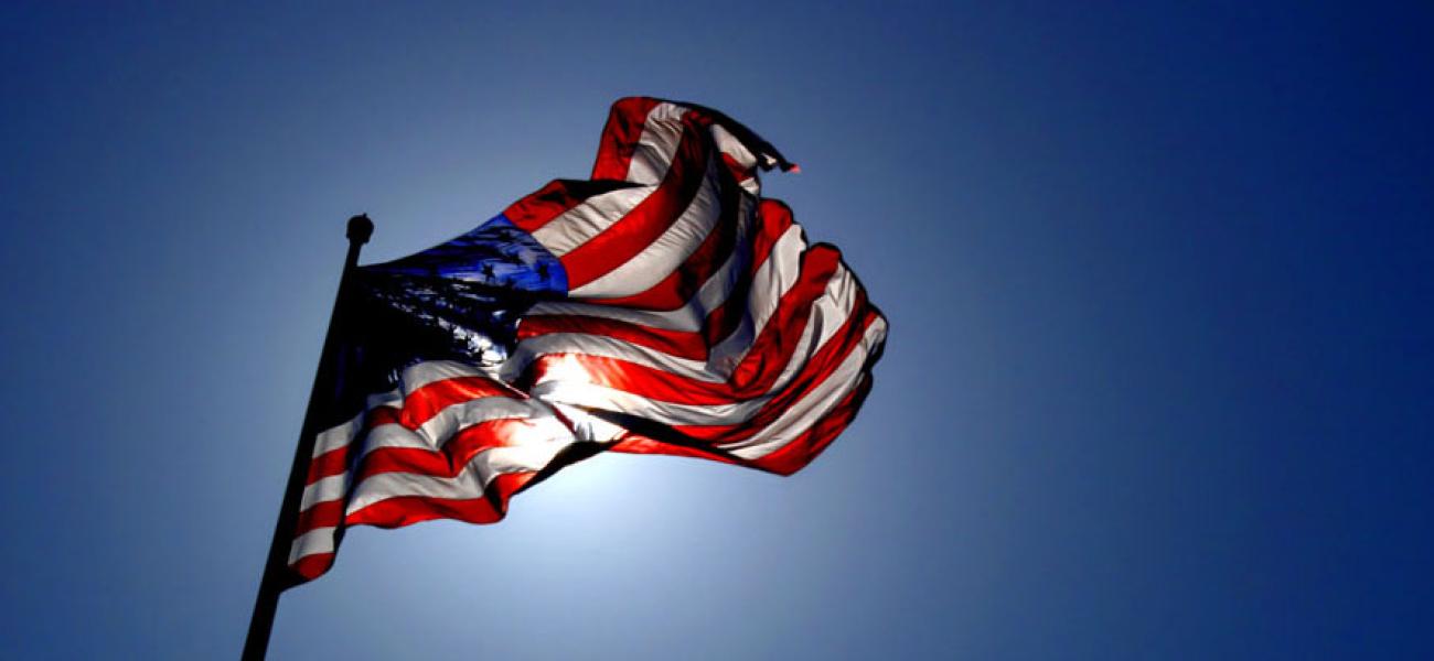 U.S. flag back lit by the sun.