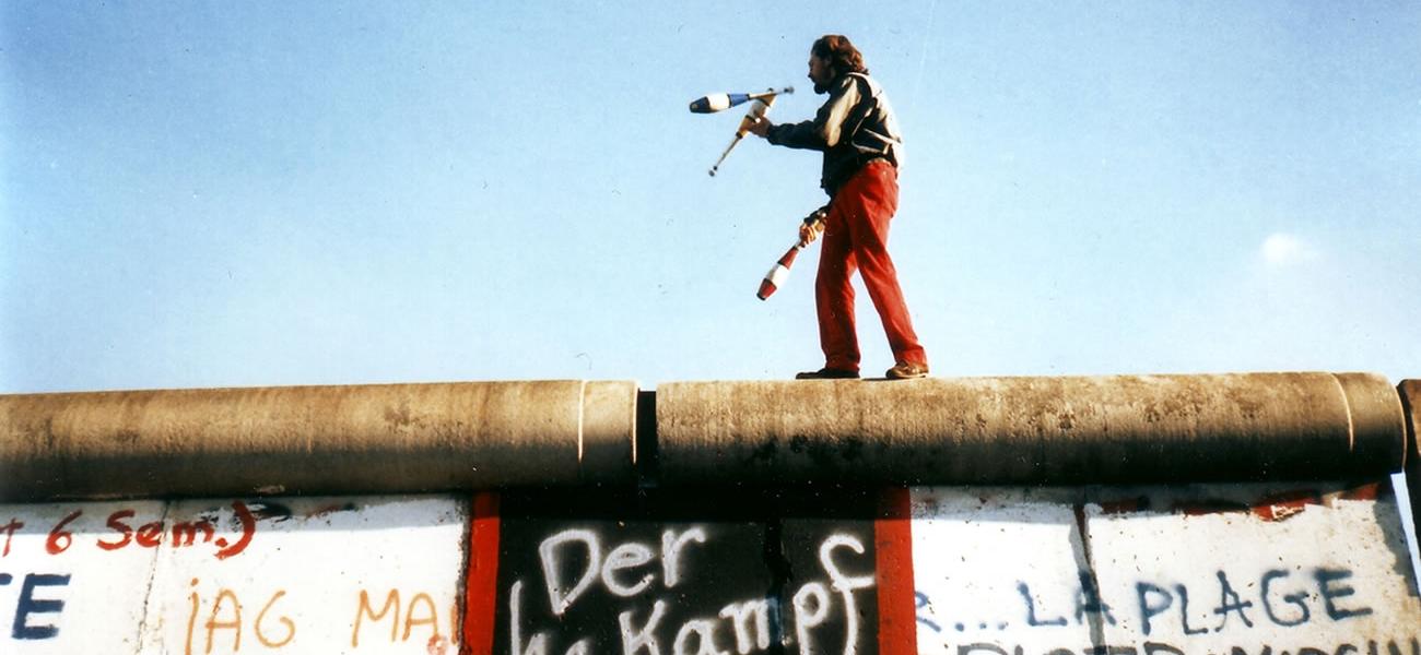 A man juggling on the Berlin Wall