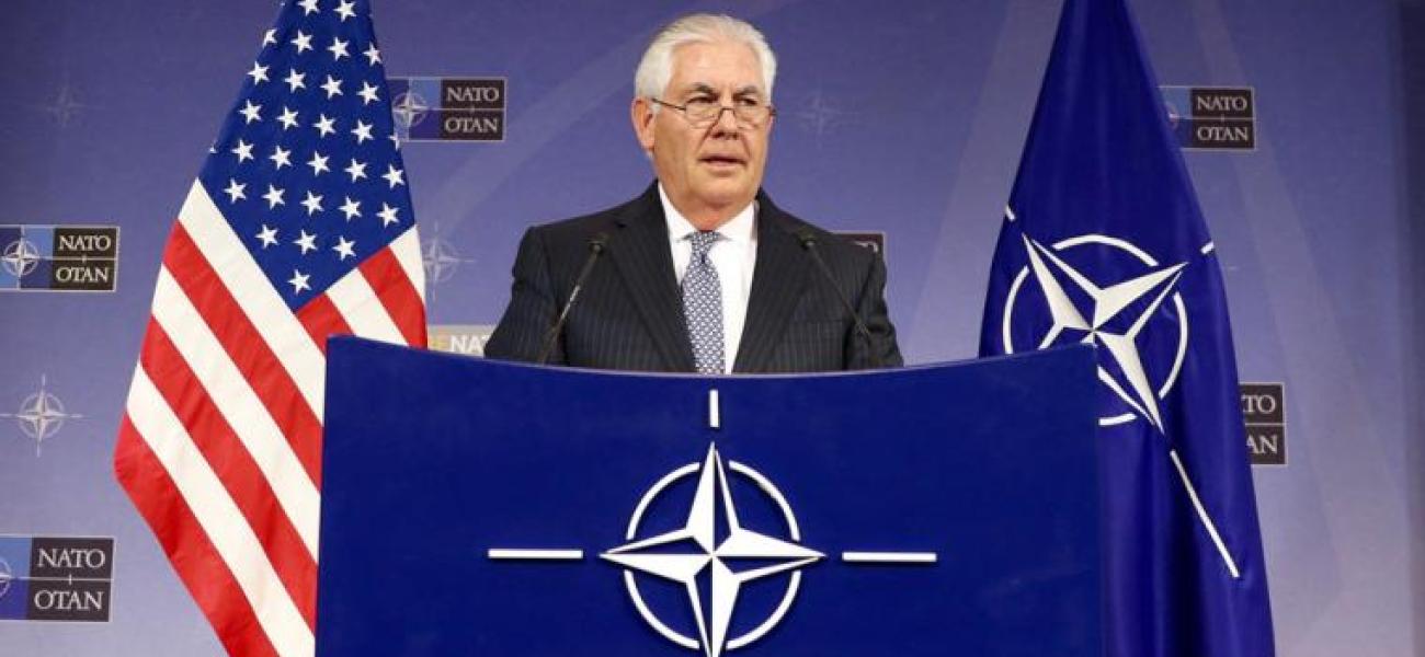 U.S. Secretary of State Rex Tillerson at a NATO podium. 