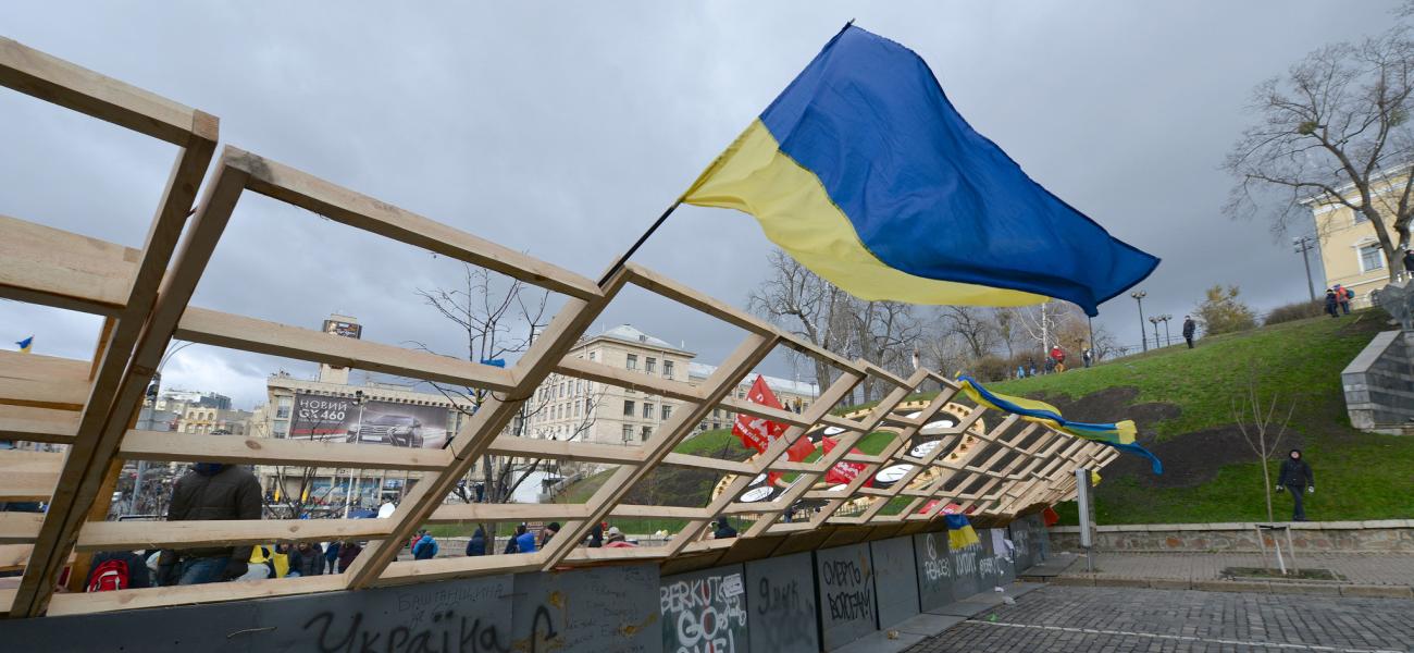 Ukrainian flag waving over graffiti.