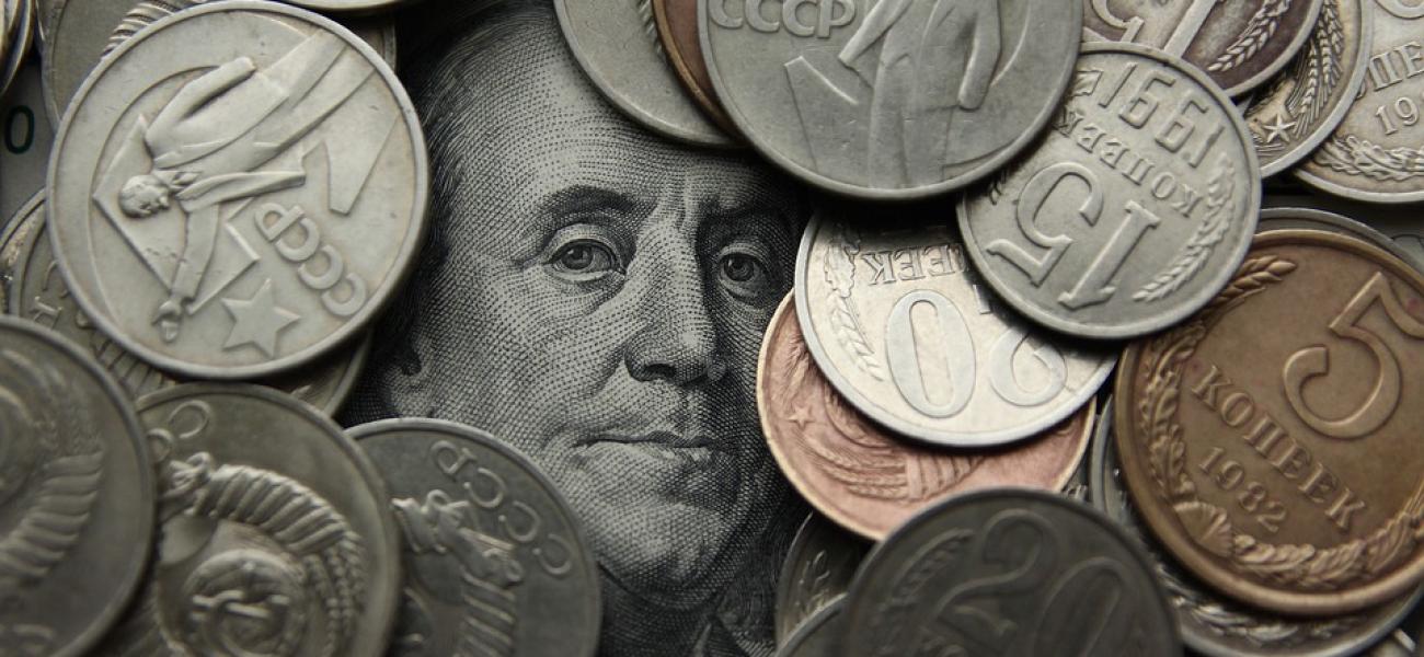 Benjamin Franklin peeking out from among Russian rubles