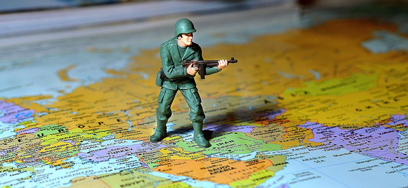 Toy soldier standing on a map of the Middle East, Iran, Israel, Syria. 